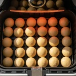 Cardamom air fryer donut holes with saffron-lemon glaze, pistachio, and rose.